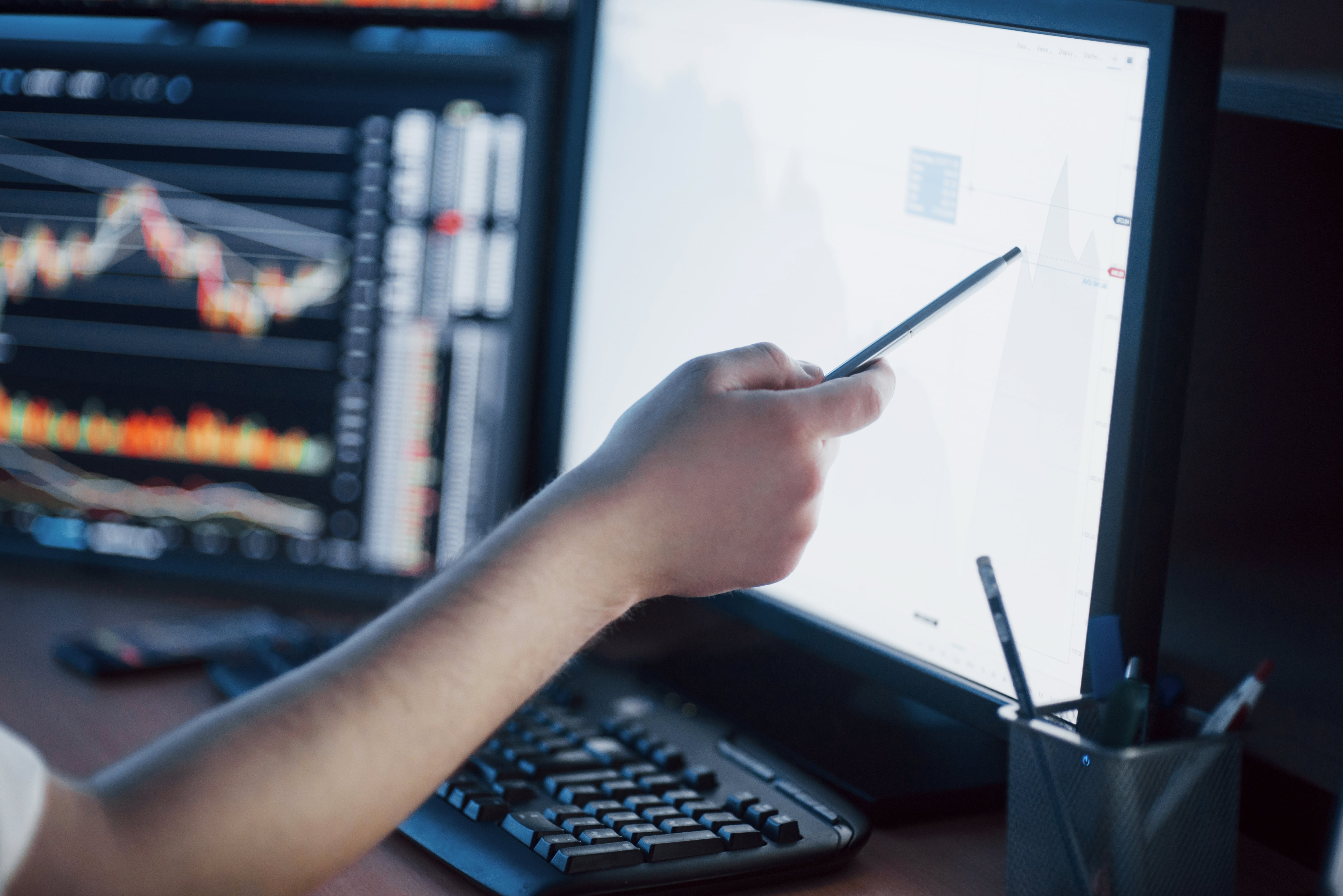 Employee watching trends at desk