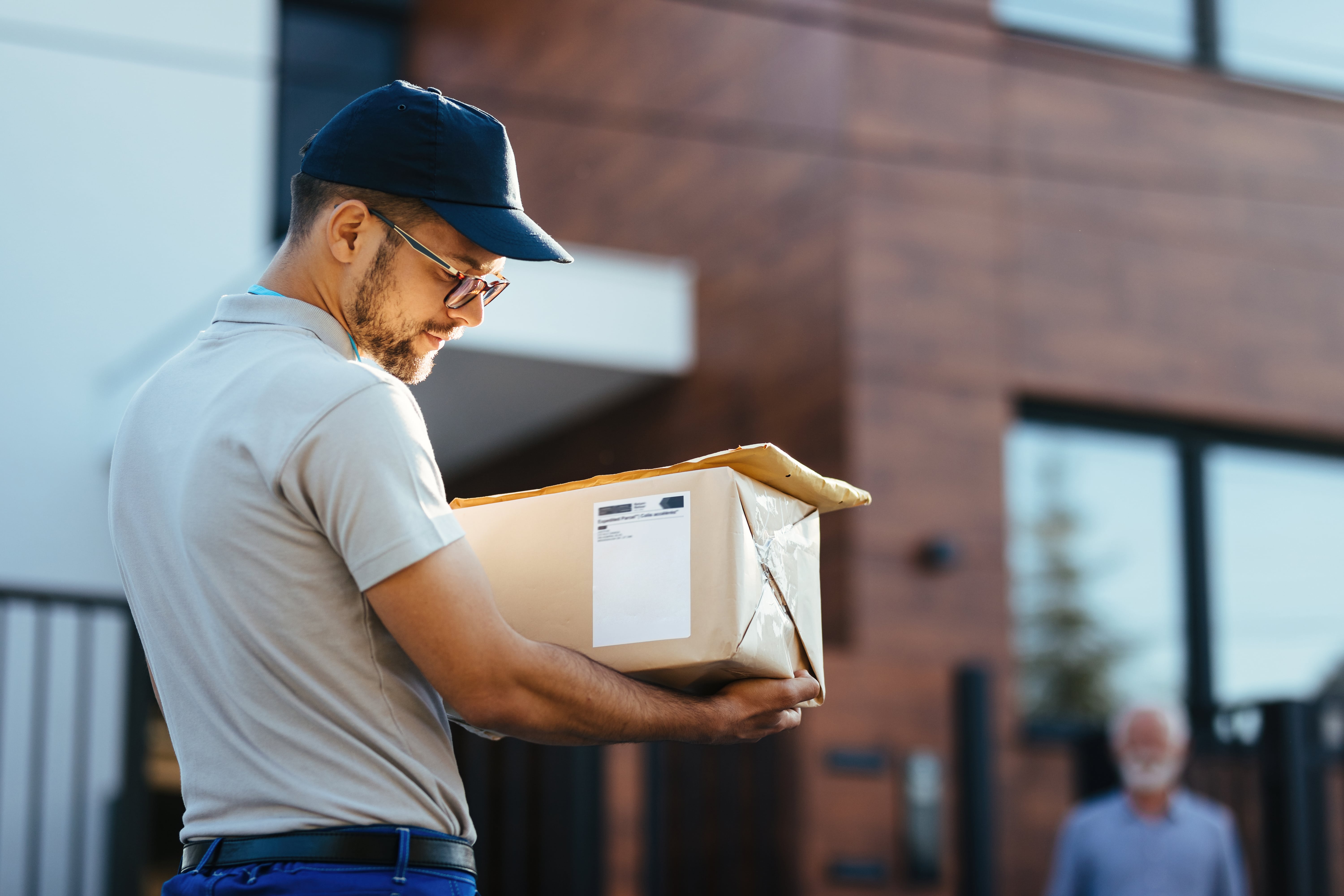 Delivery guy holding a delivery for the last mile